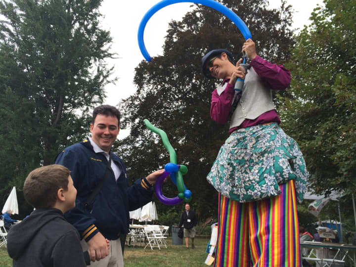 A balloon artist on stilts entertains children at Crafts at Lyndhurst. 