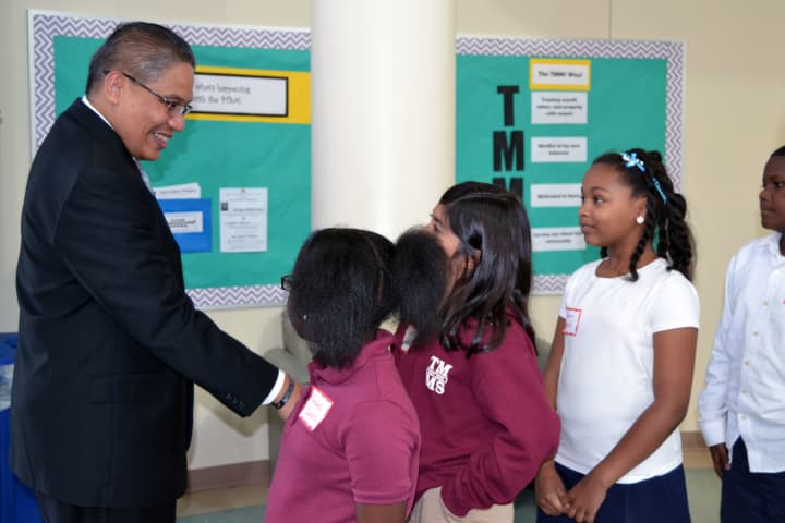 John Marshall is greeted by students in the Thurgood Marshall Middle School at Six to Six Interdistrict Magnet School in Bridgeport.