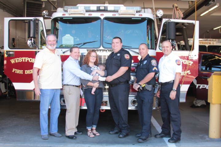 Westport Firefighter Dan Mascolo and his family were presented with a donation from The Umbrella Club on Sept. 12. 