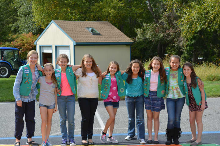 A group of North Salem Girl Scouts poses for photos at the new mural at Pequenakonck Elementary School.