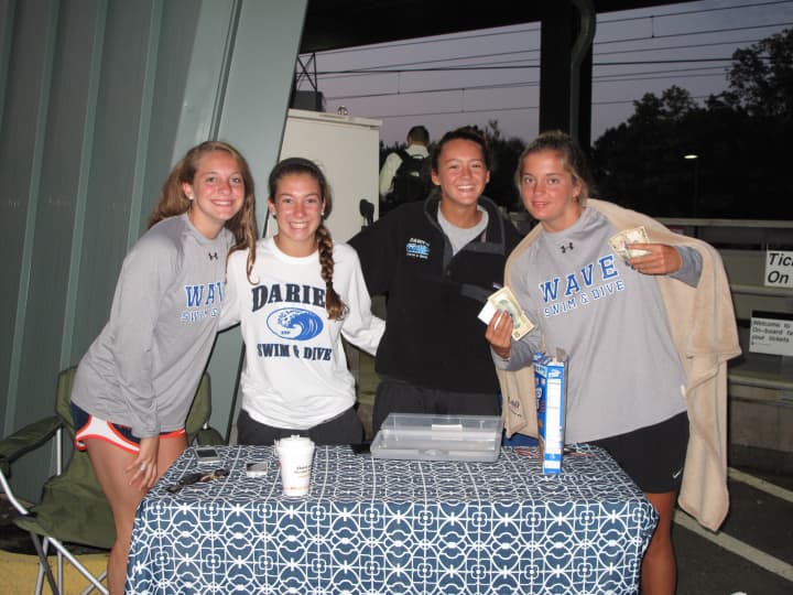 Blue Wave Swim and Dive Seniors Courtney Ferreira, Mackenzie Coughlin, Emma Jansen and Emily Nixon sold tickets to the team&#x27;s car wash.