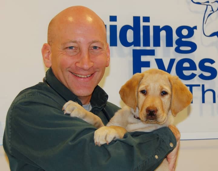 Dr. Jody Sandler, Guiding Eyes for the Blinds chief operating officer, with future guide dog Rosetta.