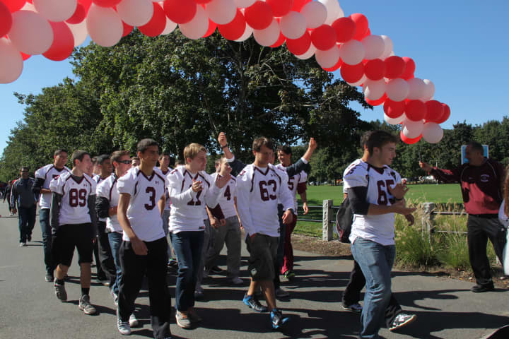 Harrison High School football players raised more than $3,100 for American Heart Association during Sunday&#x27;s walk at Kensico Dam, Valhalla. 