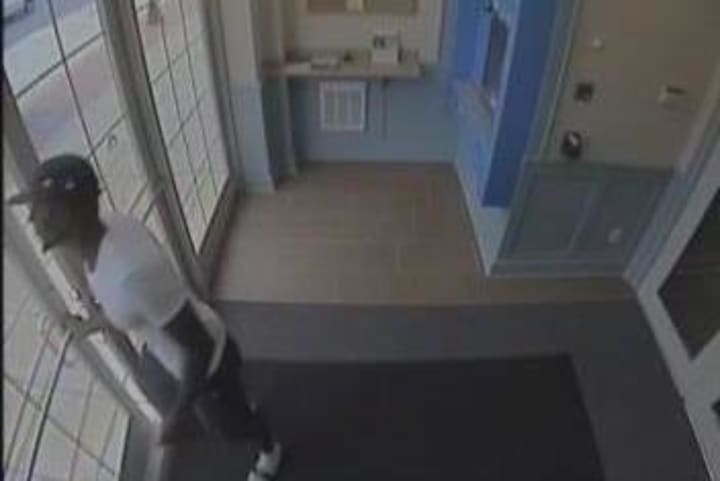 Security camera footage of a man believed to have stolen a debit card and other items from a Darien business in August.