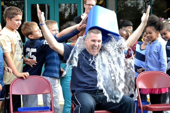 Principal Matt Curran takes the ALS challenge, and gets drenched by students. 