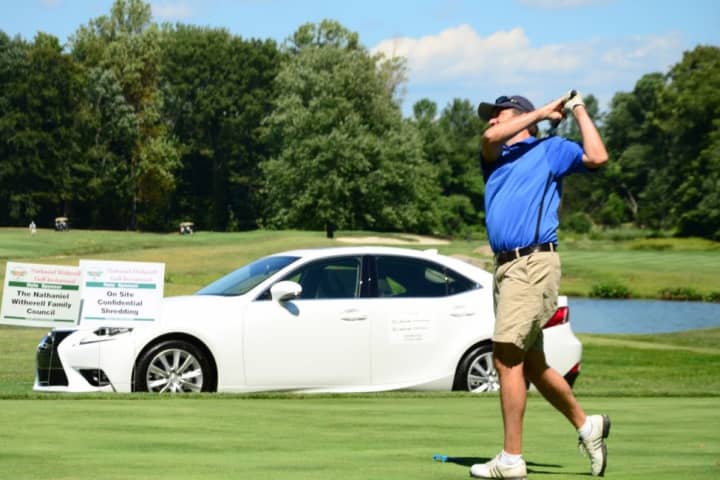 A golfer tees off on the hole-in-one contest sponsored by Lexus of Greenwich.