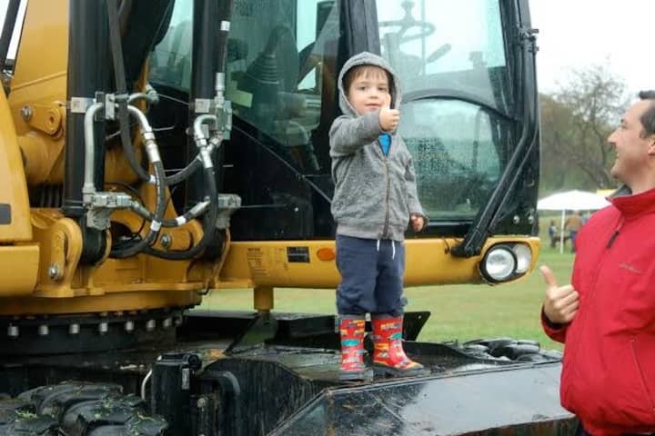 A young man enjoys the up-close experience on a piece of construction equipment at KIDZFEST, a fundraiser by the Human Services Council of Norwalk to support Children&#x27;s Connection.