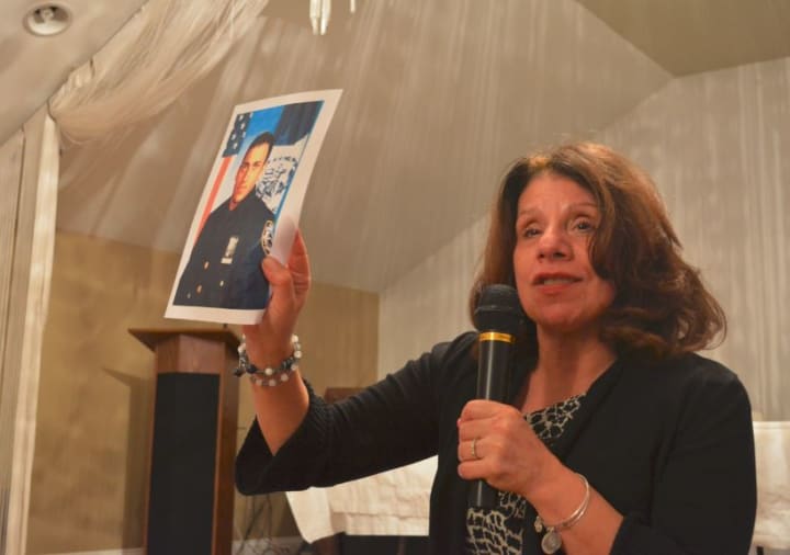Carol Christiansen holds up a picture of her son, Erik at the Somers drug forum.