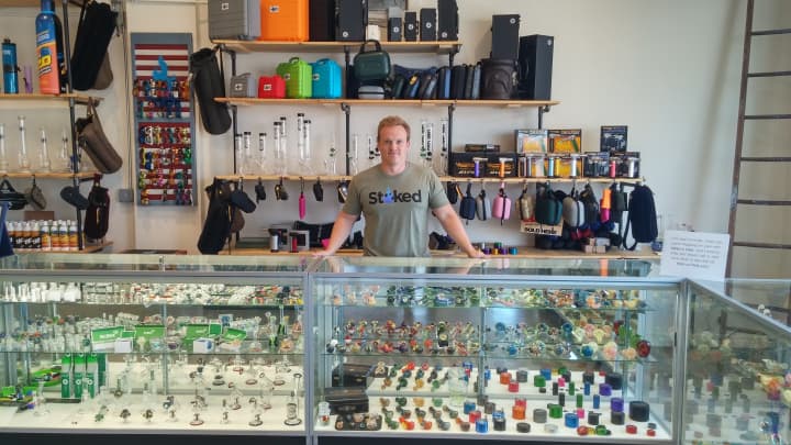 Stoked Owner Charlie Ronemus behind a display at his 4-month-old smoke shop.