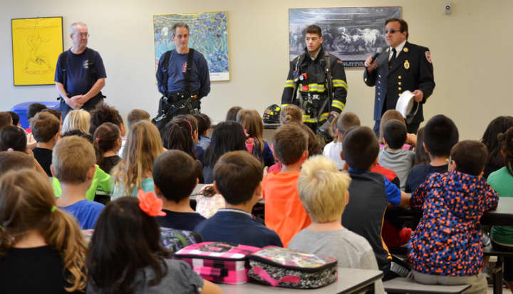 Firefighters of the Valhalla Fire Department talk to students about fire safety. 