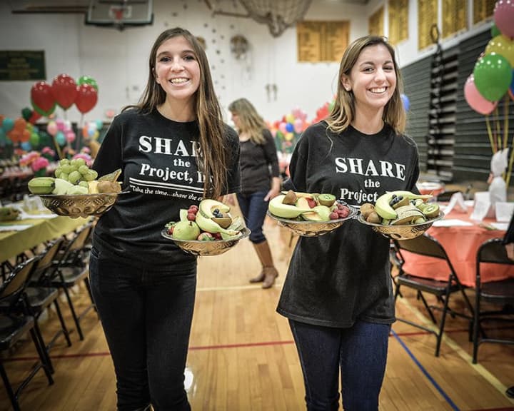 Volunteers distribute meals at Project SHARE&#x27;s 2013 Thanksgiving Dinner.