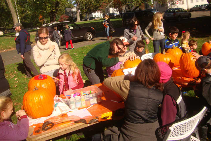 Fairfield families design their pumpkins before carving at the fifth annual Pumpkin Carving Event on St. Paul&#x27;s Green.