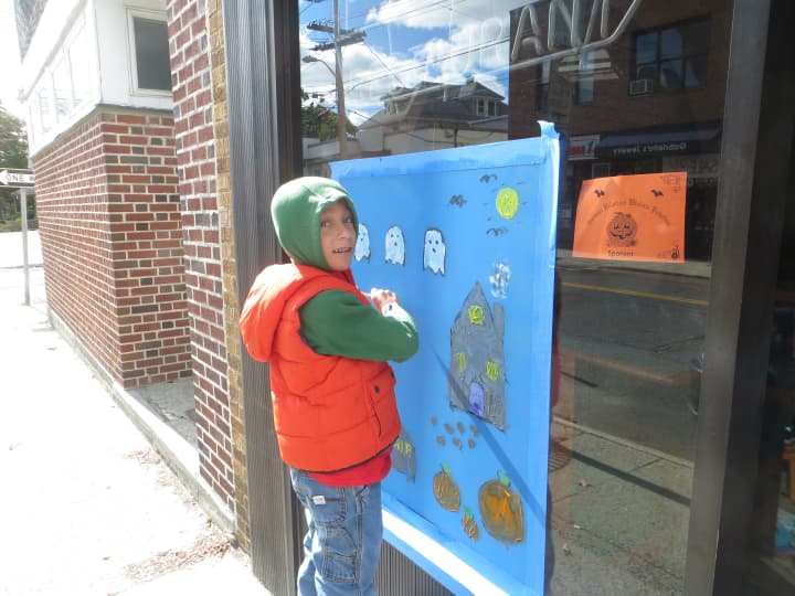 Luca Reali, a second-grader at Harrison Avenue School, puts some finishing touches on his painting at Mamma Sophia&#x27;s Pizza Restaurant. 