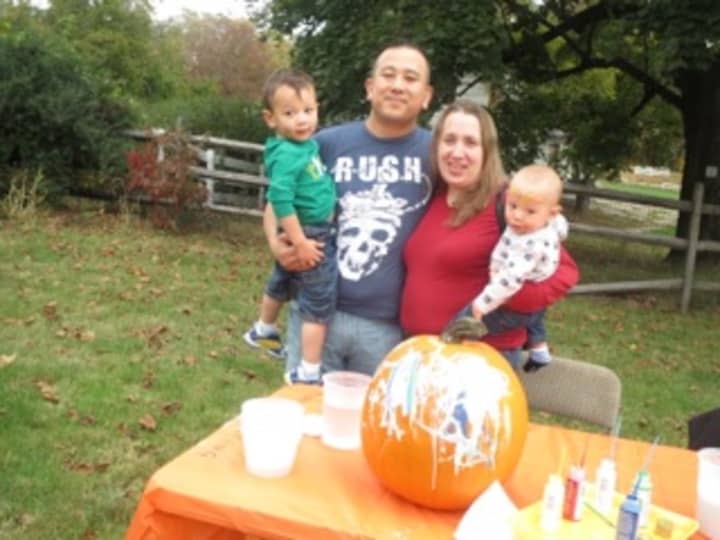 The Mui family enjoyed its morning at Hilltop Hanover Farm. Pictured are birthday boy Liam (3 on Oct. 18), his parents Michael and Stephanie, and his younger brother Colin. Liam selected his own pumpkin and then painted it.