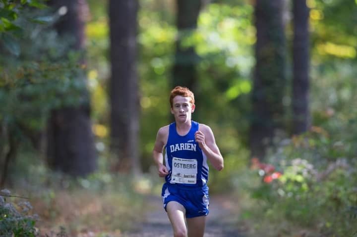 Darien&#x27;s Alex Ostberg runs away from the field Monday at the Fairfield County Interscholastic Athletic Conference championships. Ostberg announced later in the day he would be attending Stanford University next year.