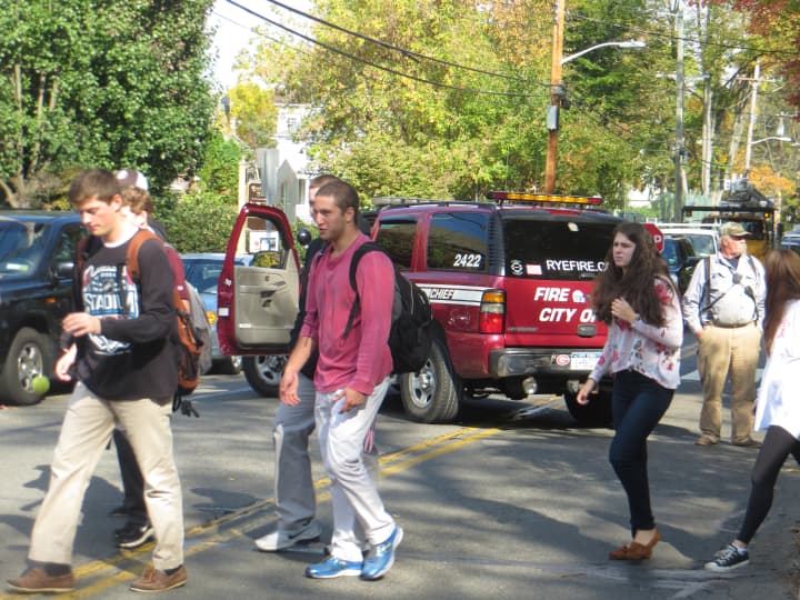 Rye High students walk back to class, crossing Milton Road, after temporarily going to Midland Elementary School.