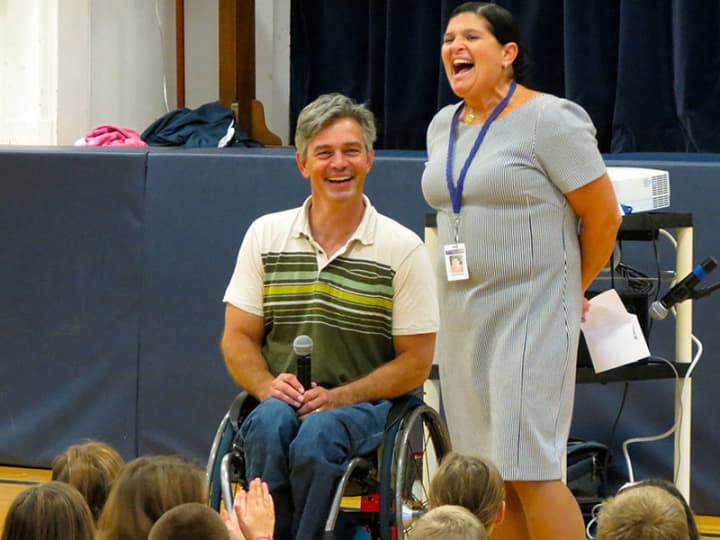 Chris Waddell, a former competitive skier at Middlebury College who is now paralyzed from the waist down from an accident on the slopes, presents to Katonah Elementary School.