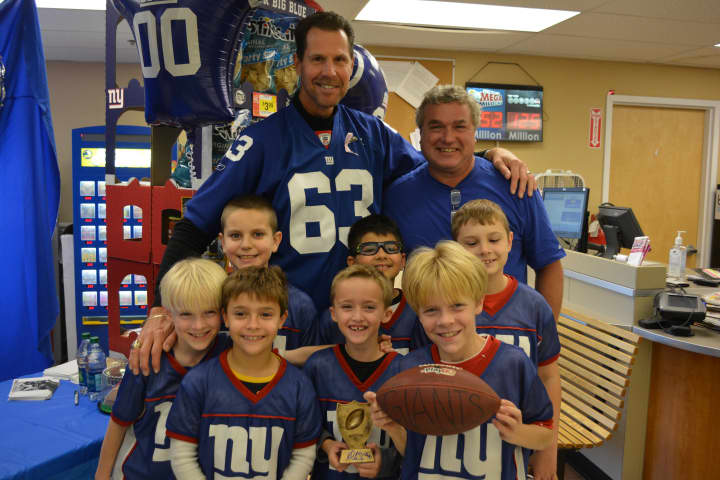 Giants meet a Giant: Karl Nelson poses for photos with members of a Mahopac flag football team.