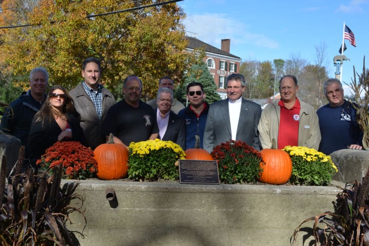 Community members pose for pictures behind the Somers water trough, which was dedicated on Sunday at Bailey Park.