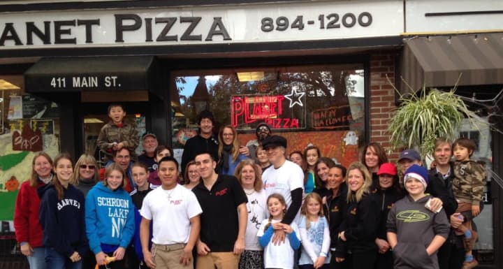 Happy walkers elebrating the end of the Mile For A Smile Walk in front of Planet Pizza in downtown Ridgefield.