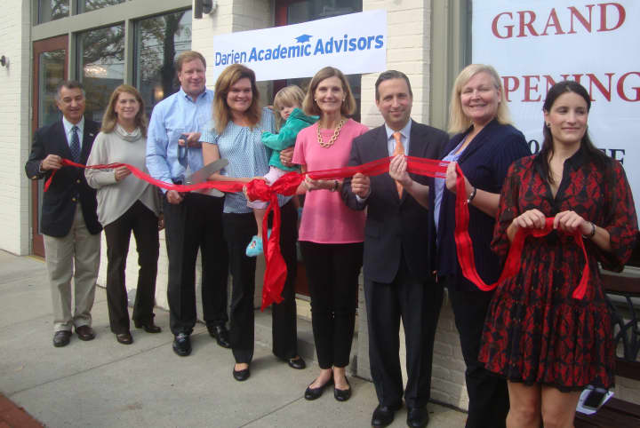 Mike and Kristin White, along with local officials and members of the Darien Chamber of Commerce, cut the ribbon to celebrate the opening of Darien Academic Advisors on Post Road.
