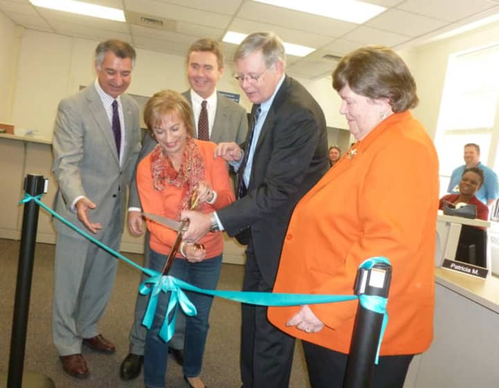 Stamford resident Mirella Liotta, center, helps cut the ribbon at the new DMV office in Stamford on Thursday. From left state Sen. Carlo Leone, state Rep. Gerald Fox, Mayor David Martin and DMV Commissioner Melody A. Currey.