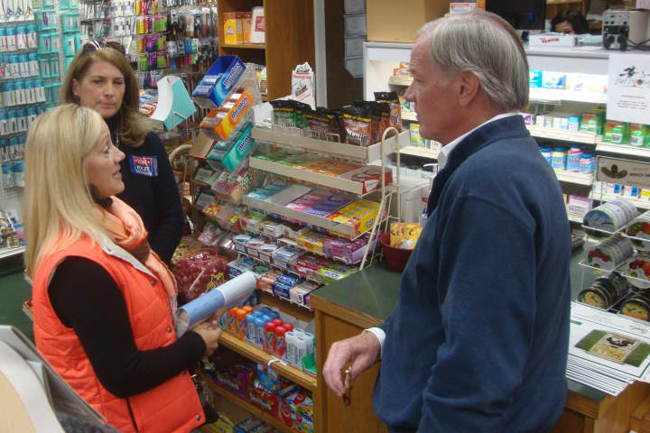 Republican candidate for governor Tom Foley chats with a woman who lost her house in Hurricane Sandy during a stop at Grieb&#x27;s Pharmacy in Darien.