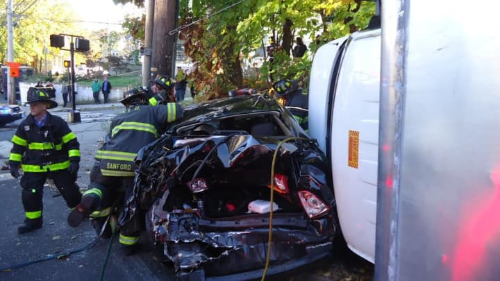 Six people are injured in a crash in South Norwalk Sunday when a box truck rolled over and a car was pinned against a pole. 