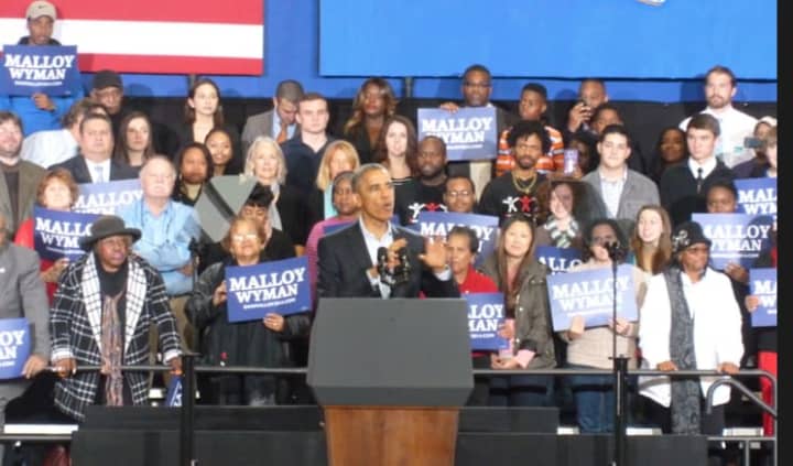 President Barack Obama takes the stage at the far end of the gym at Bridgeport&#x27;s Central High School. 