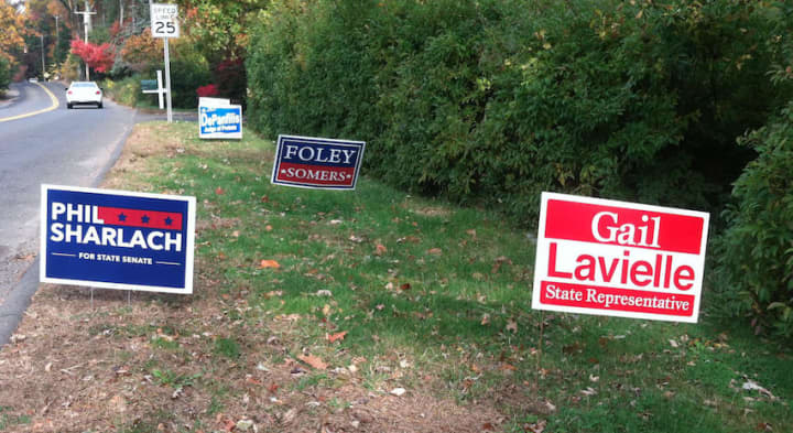 Wilton votes today in an election in which the governorship is up for grabs in a close election between Gov. Dannel P. Malloy and his Republican challenger Tom Foley. Pictured are election signs in Wilton.
