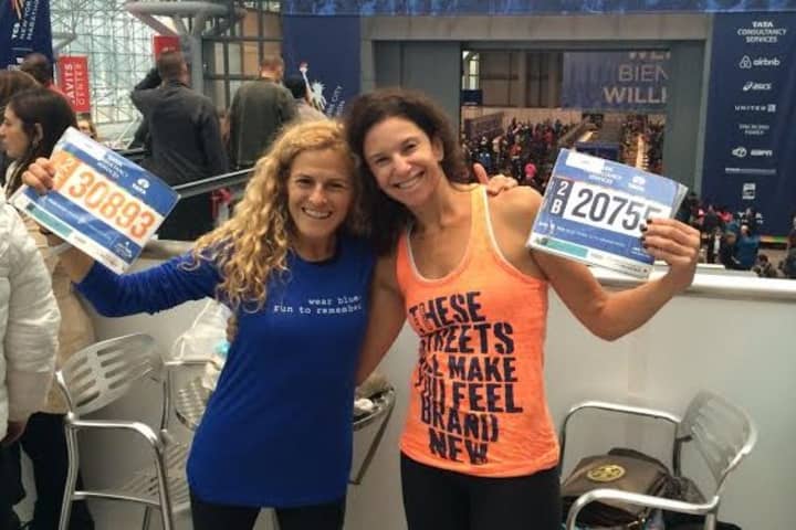 Lauren Field and Beth Segaloff of Fairfield show off their numbers prior to the TCS New York City Marathon.