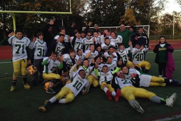 The Norwalk Packers 6th grade football team celebrates its third straight league championship.
