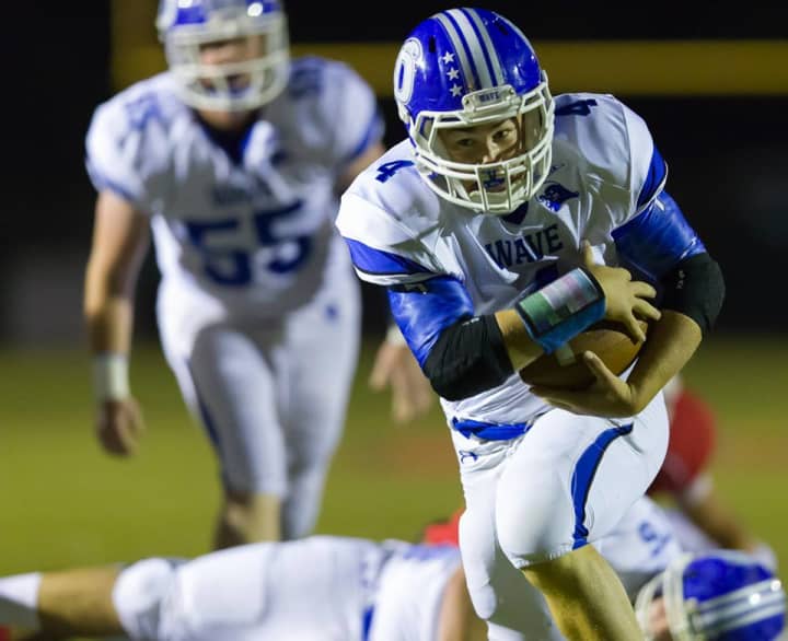 Darien&#x27;s Peter Archey runs for yardage during a game earlier this year.