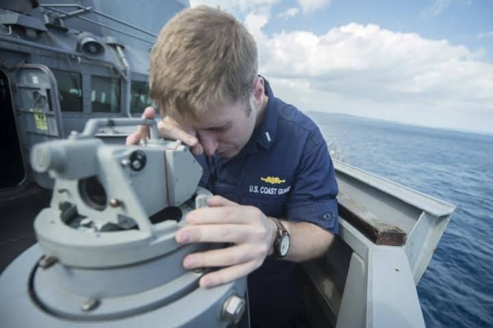 Coast Guard Lt. Jacob Christopher Hauser, from North Salem, N.Y., uses an alidade to take range and bearing from the port bridge wing of the Arleigh Burke-class guided missile destroyer USS Stethem (DDG 63).