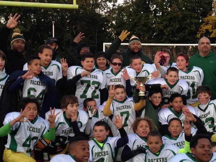 The Norwalk Packers 6th grade football team celebrates after winning the state championship.