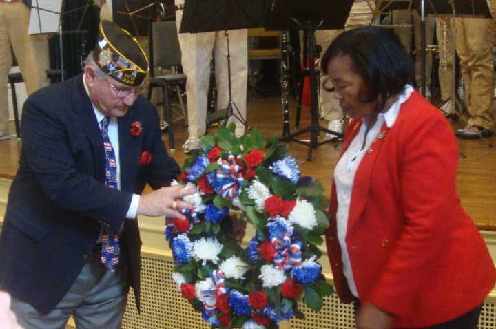 Members of the VFW and American Legion place a ceremonial wreath in front of the stage at Westport Town Hall.
