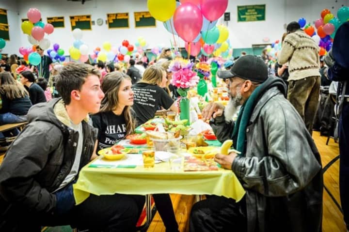 Volunteers and guests chat at Project SHARE&#x27;s annual Thanksgiving dinner.