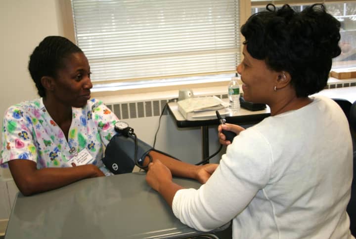 LPN students practicing their blood pressure monitoring skills on each other. 