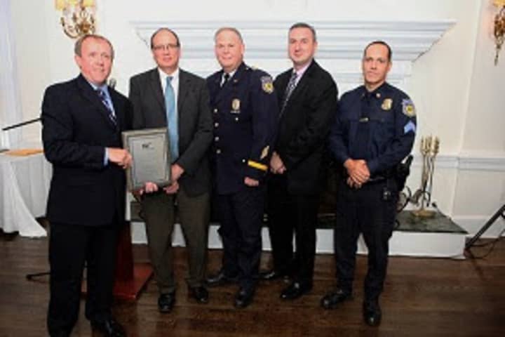 John Corlett, director of Traffic Safety for AAA New York, presents the Platinum Award for Community Traffic Safety to White Plains to Thomas Soyk, Capt. Nicholas Kralik, Anthony Merena and Sgt. Marco Garced.