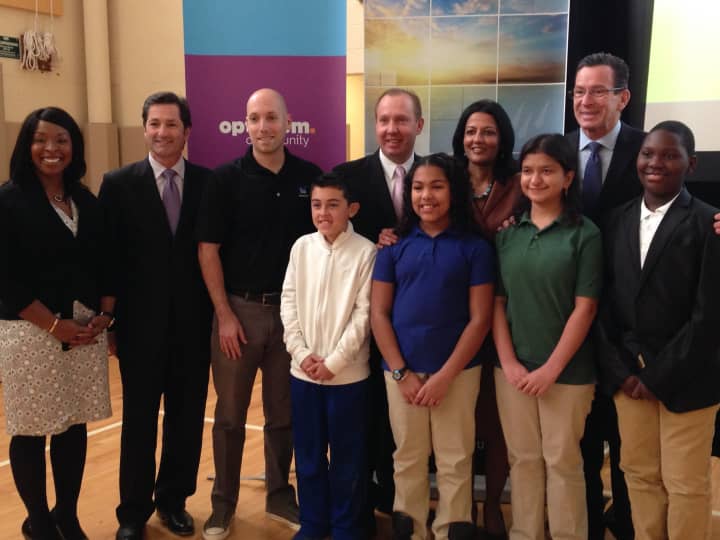 Gov. Dannel Malloy and Mark Elliott of The Weather Channel pose with students Wednesday at Inter-district Discovery Magnet School in Bridgeport. 
