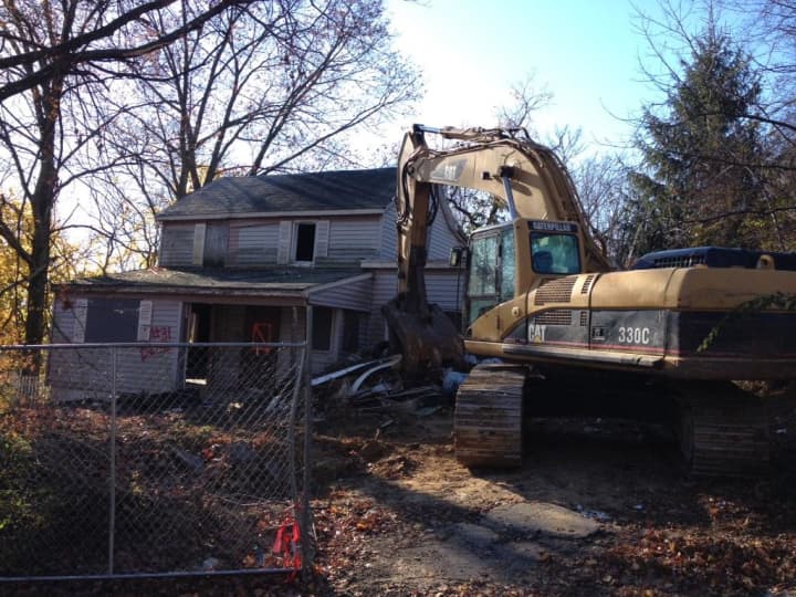 This blighted property on Clifton Place was demolished Wednesday to make way for a future home for a family with a special needs child. 