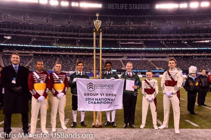 Norwalk High band leaders (left to right) Thomas Jankovic,  Jeffrey Victor, Lynna Bray accept the trophy after winning Saturday, Nov. 15, at the U.S. Bands Open Class competition in New Jersey.