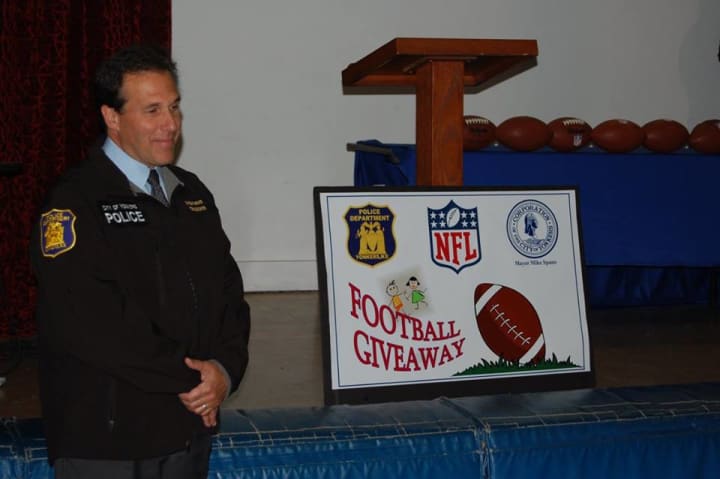 Comnissioner Charles Gardner distributed footballs provided by the NFL to St. Peter&#x27;s Church.