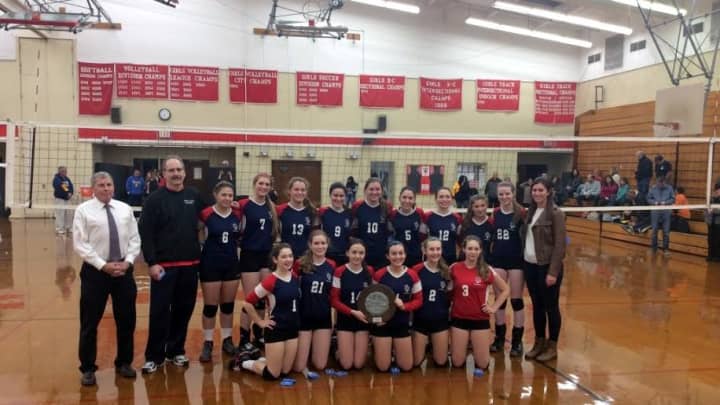 The Kennedy Catholic varsity volleyball team poses for a team picture with the plaque after winning the CHSAA City Championship on Saturday, Nov. 8.