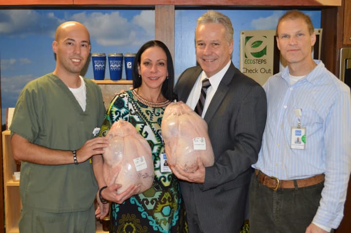 Mike Carreira (pharmacy), Annemarie Beall (pharmacy), Dr. William Higgins (vice president of medical affairs) and team captain Mark Lovitz (pharmacy) hold some of the turkeys they will be carrying in Saturday&#x27;s race.