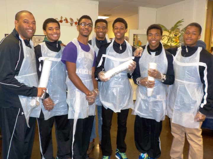 Members of the New Rochelle High School boys varsity basketball team helped serve lunch to seniors.