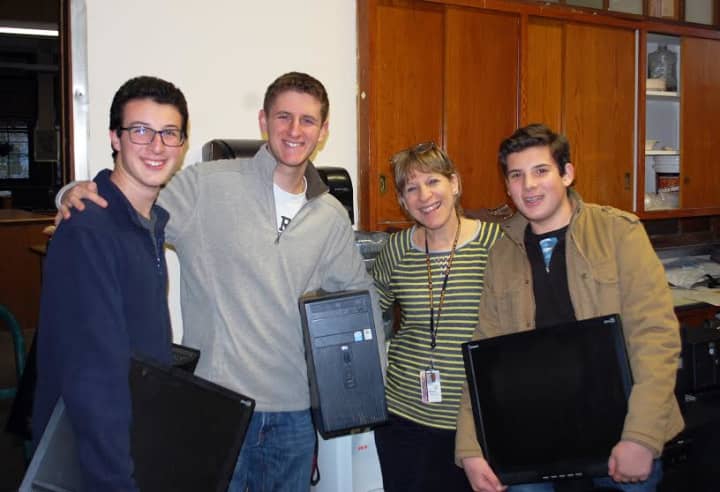 Alec, Aaron and Mitch Feldman, with Barbara Peist, who teaches English at Nellie A. Thornton H.S., in Mount Vernon.
