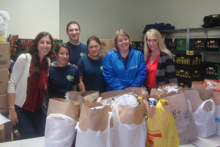 Tauck employees Julia O&#x27;Brien, Kristen Kaczegowicz, Aaron Wasserman, Emily Yip, Jennifer Catalano and Sharon Bell pack up Thanksgiving meals at Person-To-Person in Norwalk.