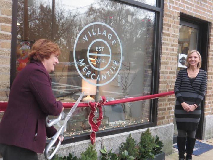 Larchmont Mayor Anne McAndrews, left, cuts the ribbon Tuesday outside the village&#x27;s newest business at  28 Chatsworth Ave.