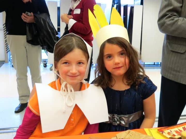 Increase Miller Elementary School first-graders Megan, left, and Cordelia wore Pilgrim and Native American attire to the feast.
